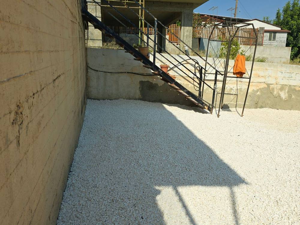 After: white gravel by the staircase
